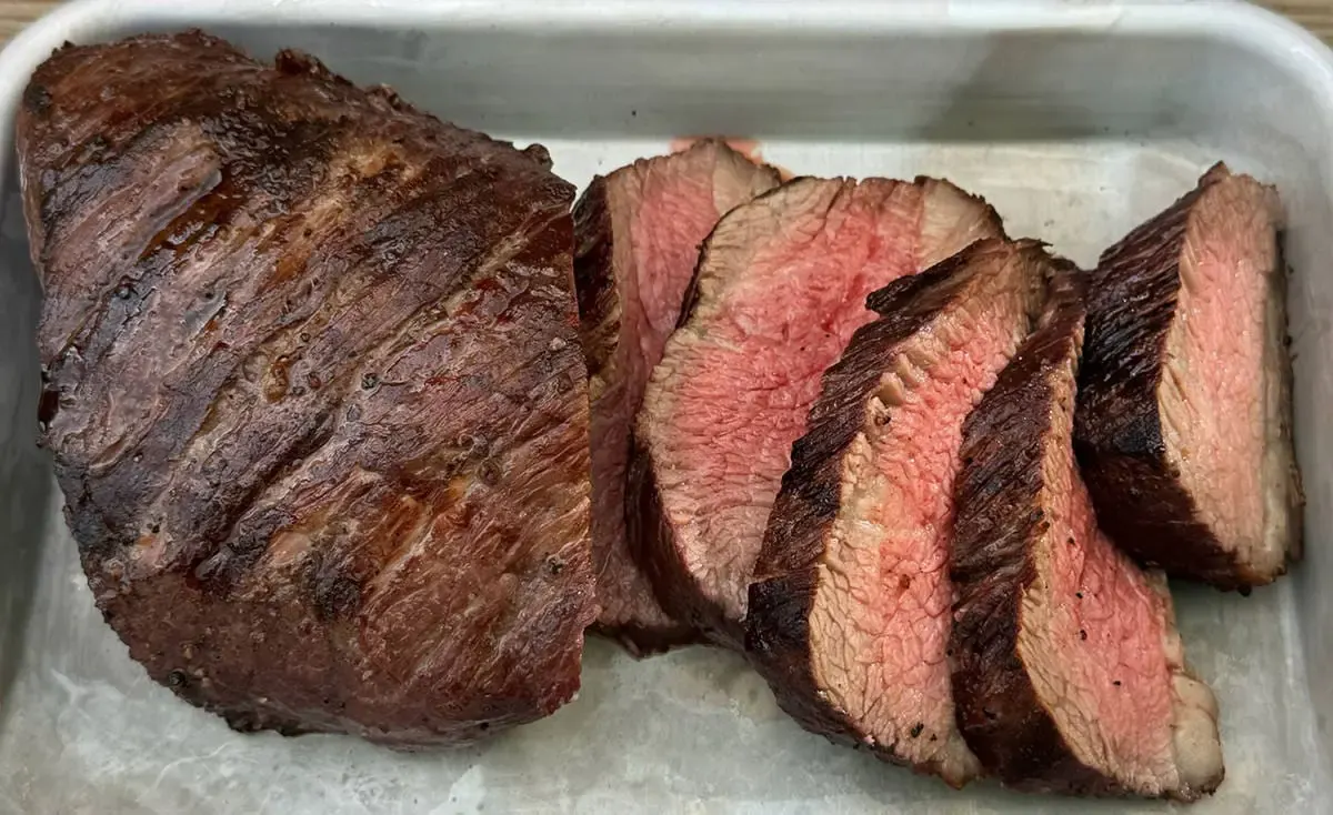 Sliced medium-rare Cardiff Crack tri-tip fanned out on ice at the butcher counter